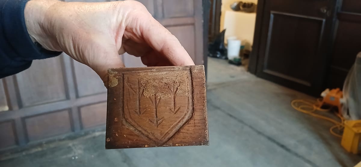 Wooden bracket from Tamworth Castle carved with three arrows inside a shield