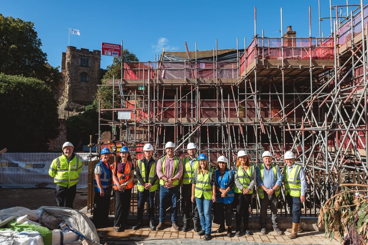 A group beside the scaffolded Market Street properties next to Tamworth Castle