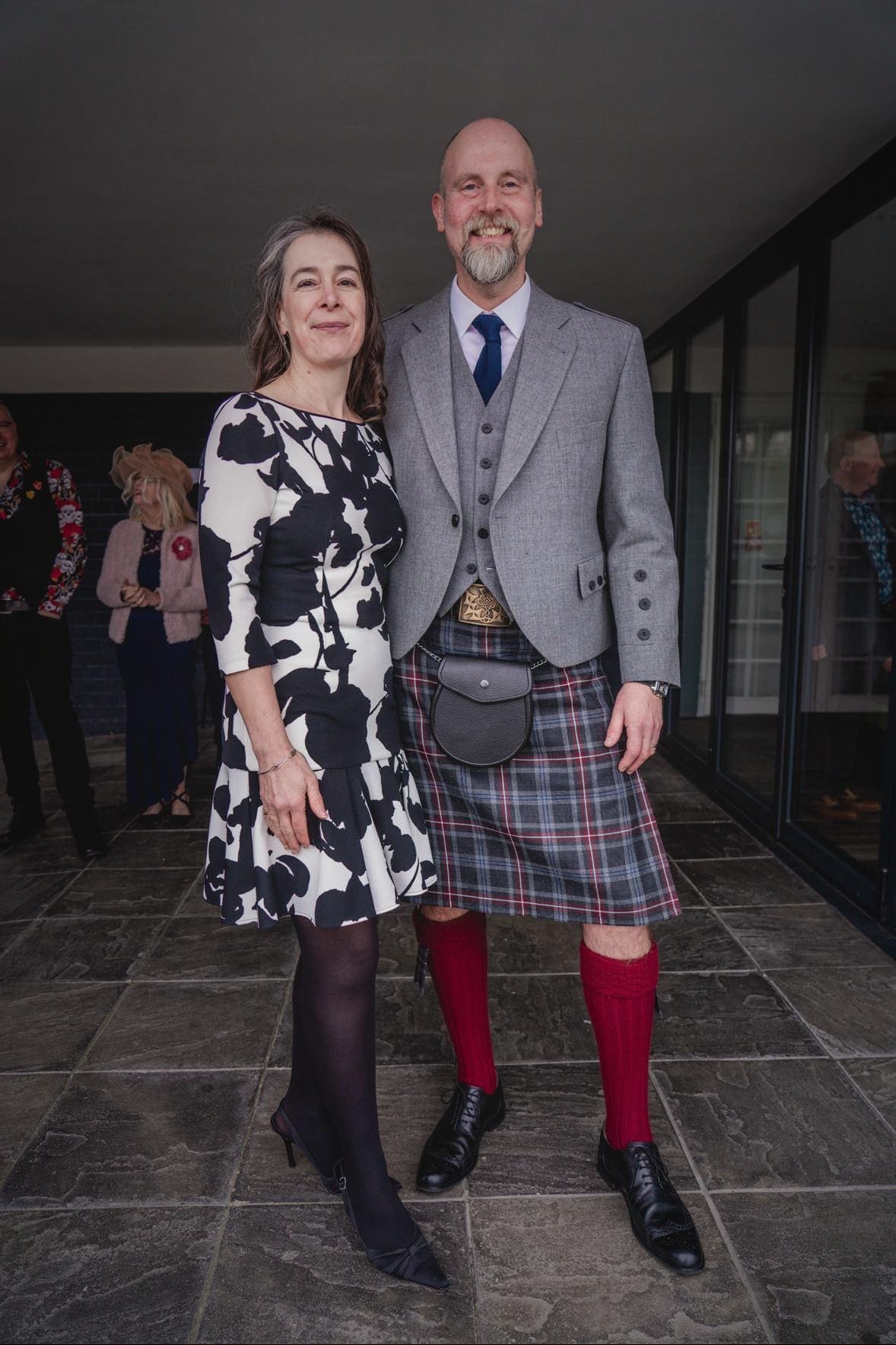 Gillian standing beside another person in the supplied photograph