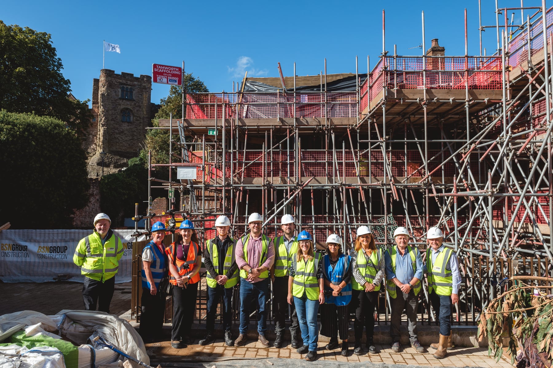 A group beside the scaffolded Market Street properties next to Tamworth Castle