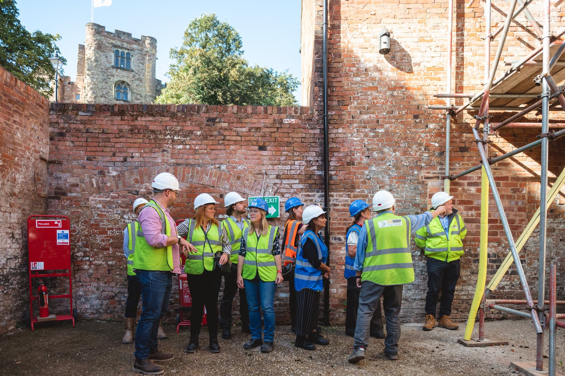 Visitors wearing hard hats inside a Market Street property undergoing restoration
