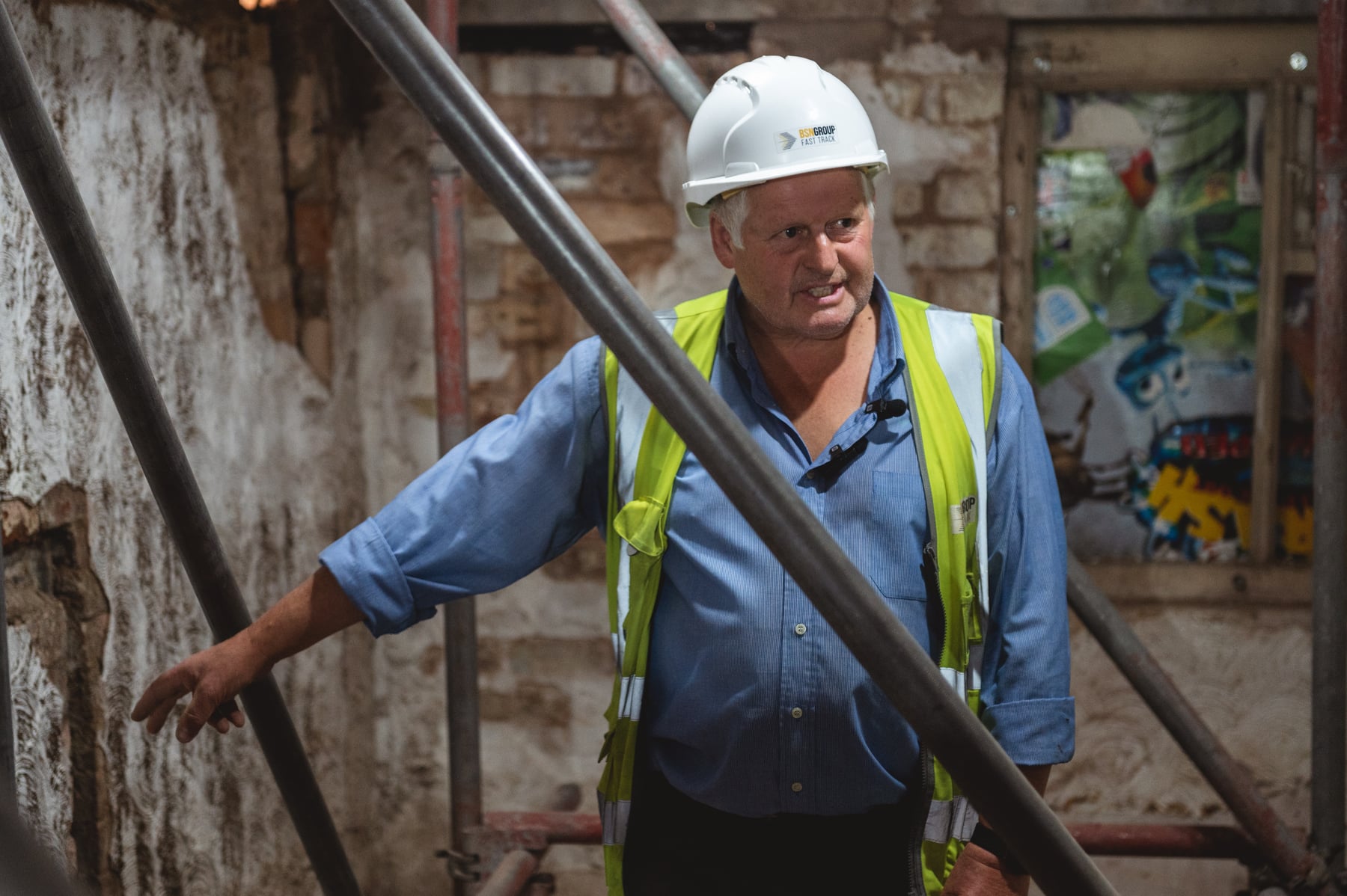 A member of the restoration team examining a wall inside a Market Street property